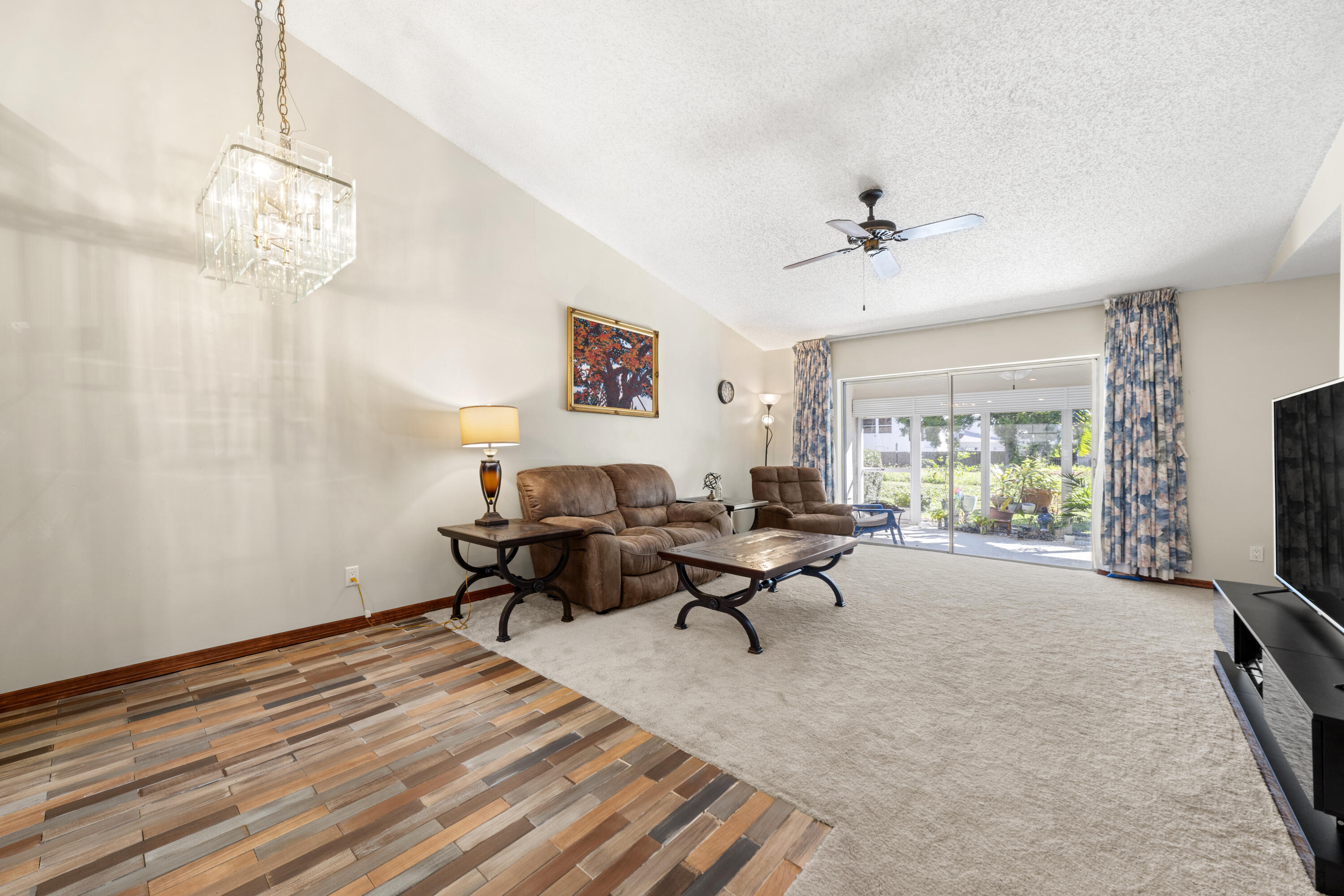 197 Bent Arrow Drive Jupiter, FL 33458 - Photo 7 of 33 a living room with furniture a window and a flat screen tv