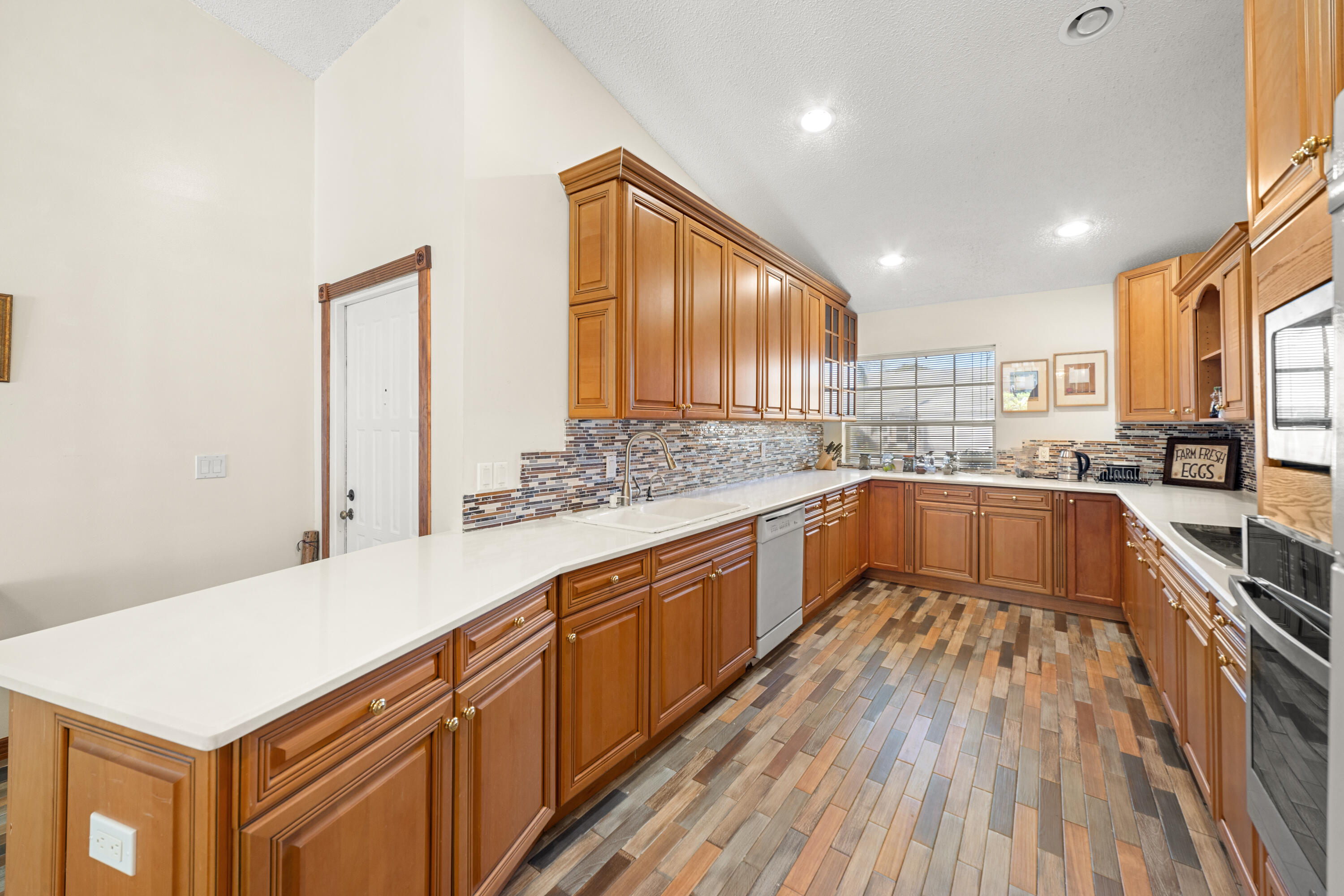 197 Bent Arrow Drive Jupiter, FL 33458 - Photo 8 of 33 a large kitchen with stainless steel appliances granite countertop a lot of counter space and wooden floors