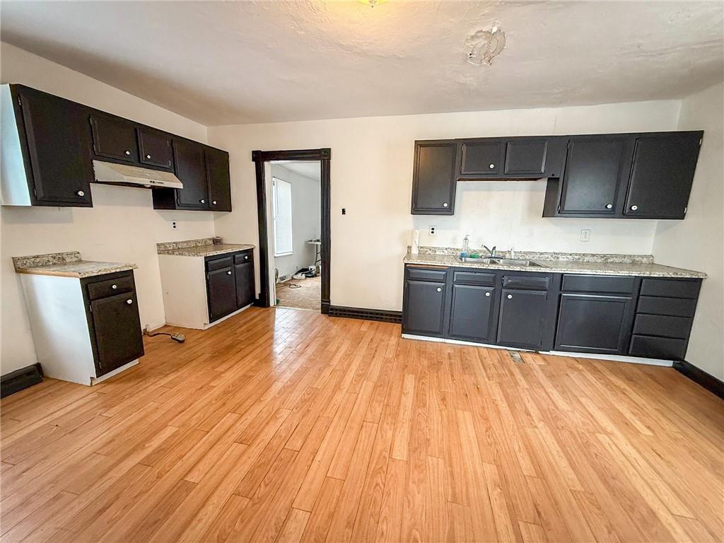 548 West Brady Street Butler, PA 16001 - Photo 11 of 36 a kitchen with stainless steel appliances a kitchen island hardwood floor sink stove dining table and chairs