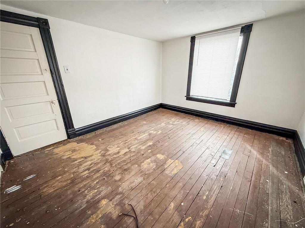 548 West Brady Street Butler, PA 16001 - Photo 22 of 36 a view of empty room with window and wooden floor