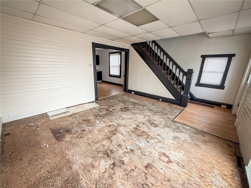 548 West Brady Street Butler, PA 16001 - Photo 4 of 36 a view of an empty room with stairs and wooden floor