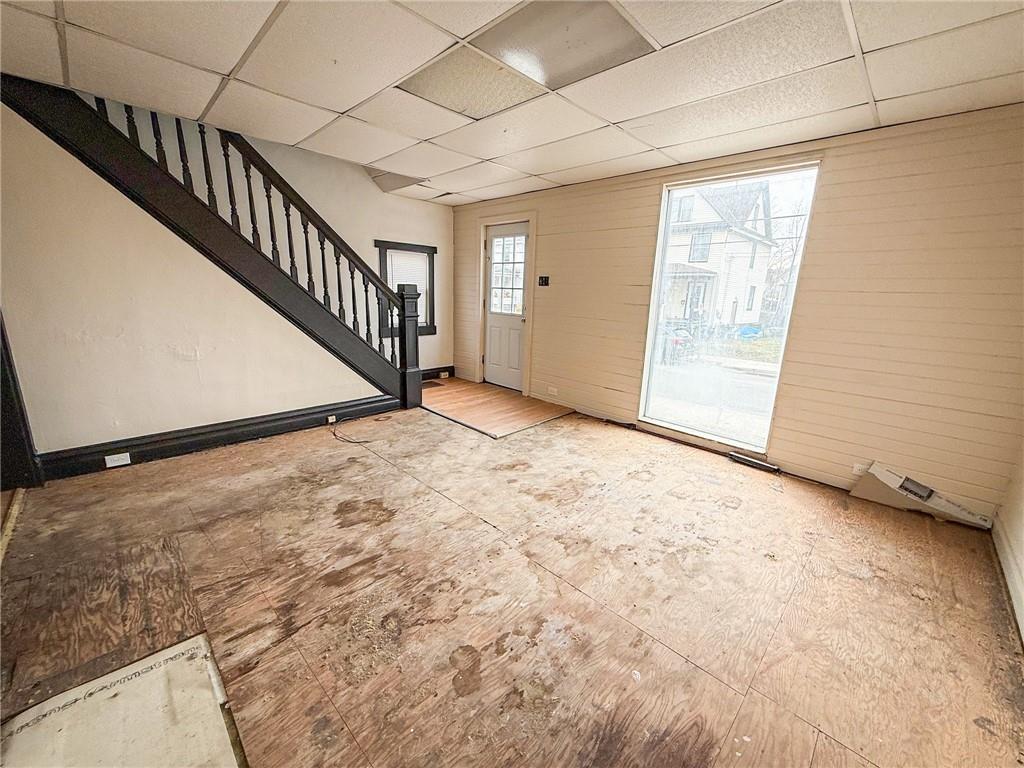 548 West Brady Street Butler, PA 16001 - Photo 5 of 36 a view of an empty room with wooden floor and stairs