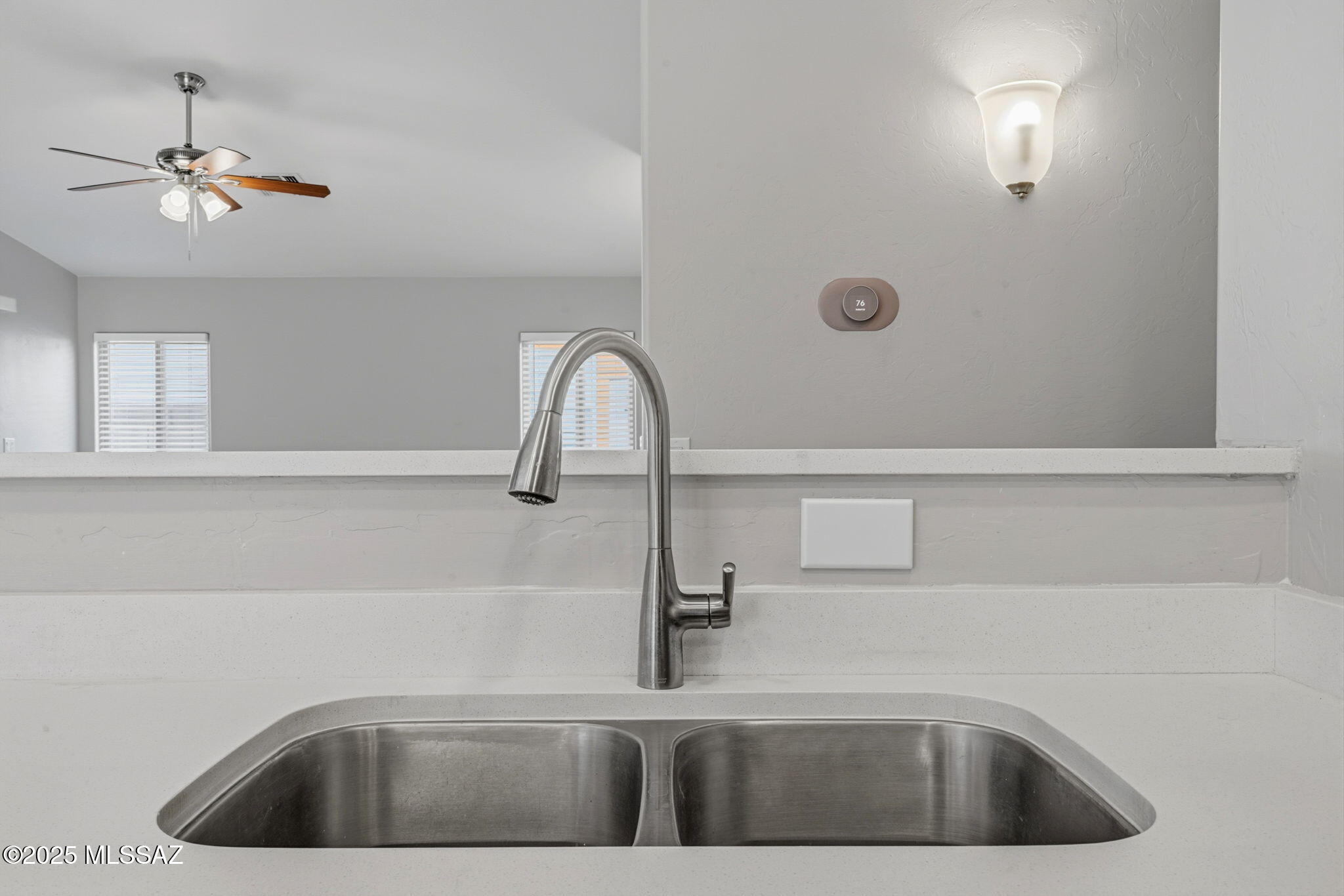 8244 South Lost Mountain Road Tucson, AZ 85747 - Photo 11 of 41 a kitchen with a sink a faucet a light fixture and a window