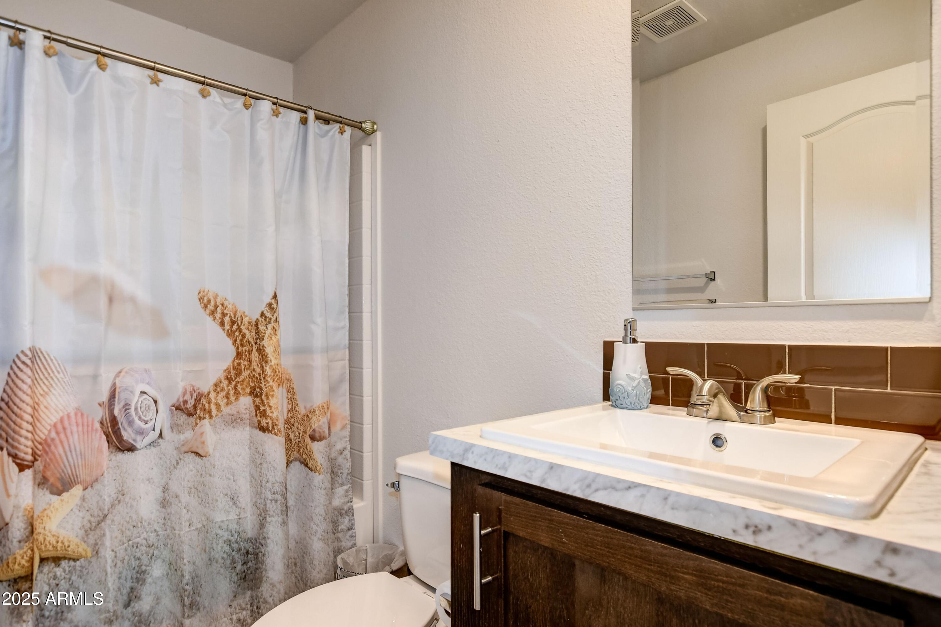 1787 East Perkinsville Road Chino Valley, AZ 86323 - Photo 11 of 13 a bathroom with a granite countertop sink and a mirror