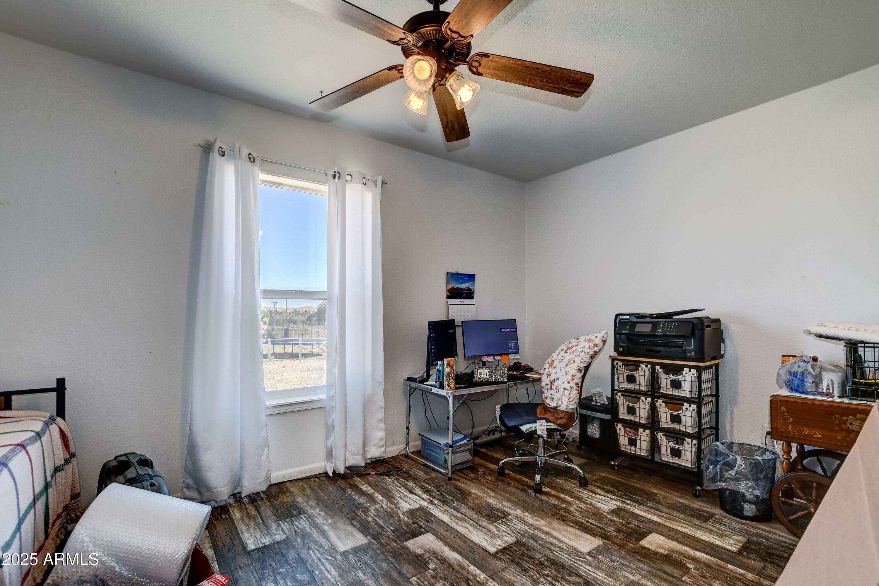 1787 East Perkinsville Road Chino Valley, AZ 86323 - Photo 12 of 13 a workspace with wooden floor and a window