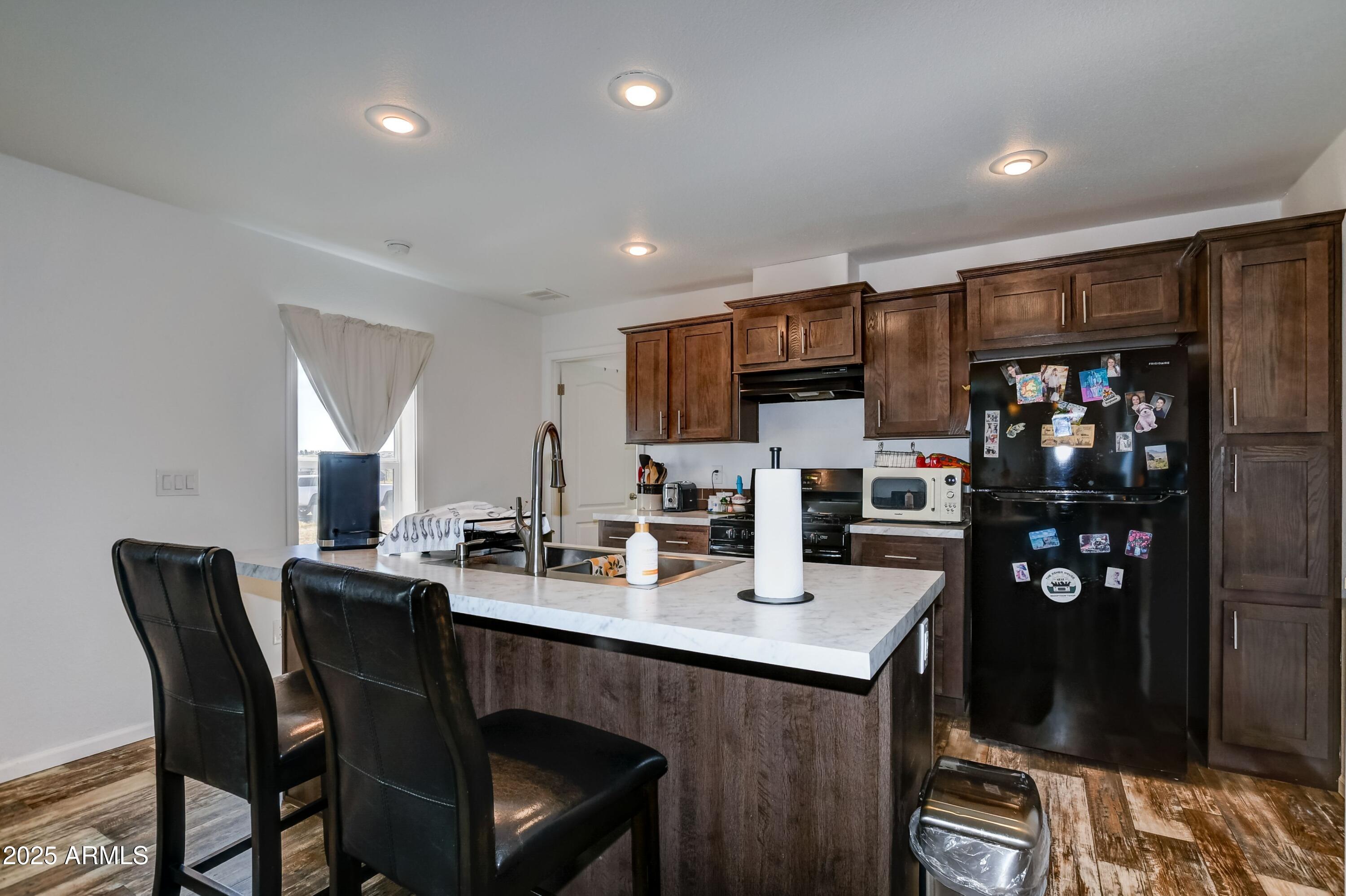 1787 East Perkinsville Road Chino Valley, AZ 86323 - Photo 6 of 13 a kitchen with a dining table cabinets and appliances
