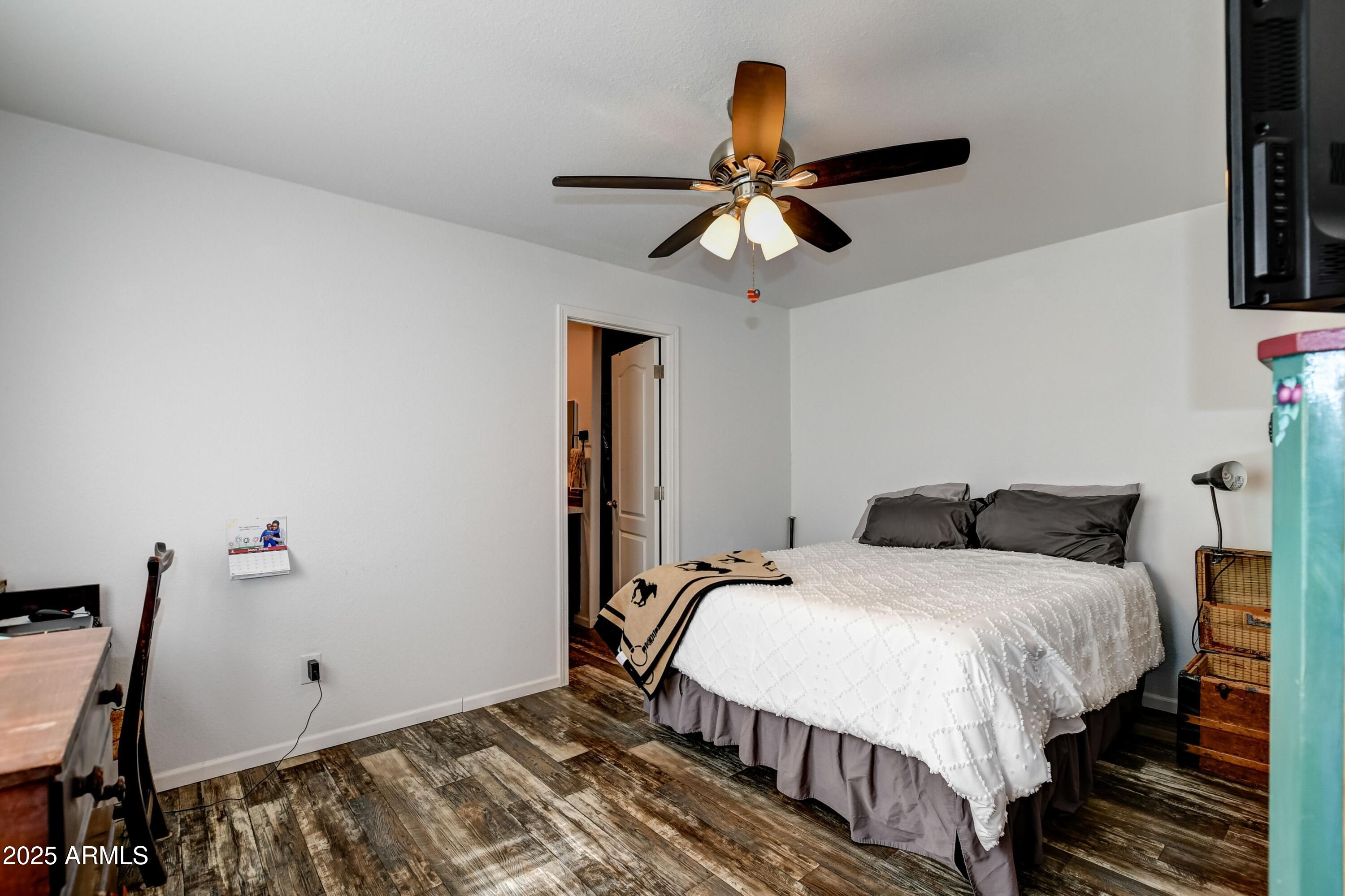 1787 East Perkinsville Road Chino Valley, AZ 86323 - Photo 10 of 13 a bedroom with bed and a chandelier