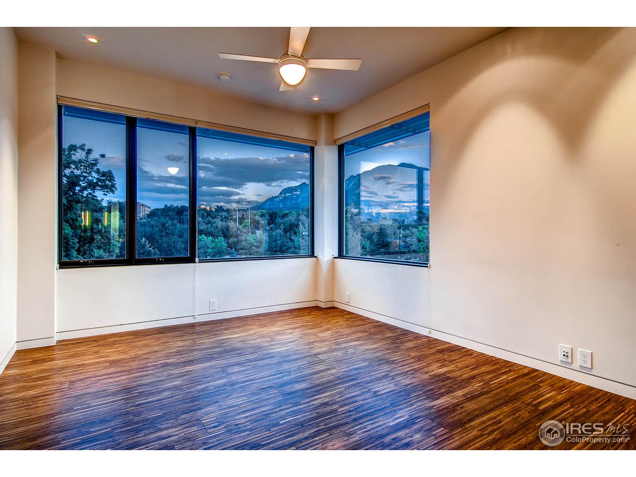 1701 15th Street, Unit 302 Boulder, CO 80302 - Photo 11 of 25 a view of an empty room with wooden floor and a window