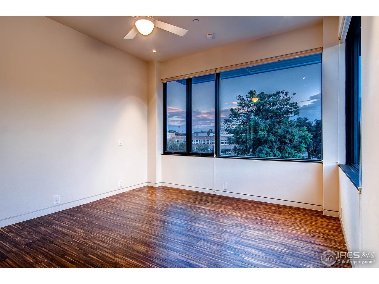 1701 15th Street, Unit 302 Boulder, CO 80302 - Photo 12 of 25 a view of an empty room with wooden floor and a window