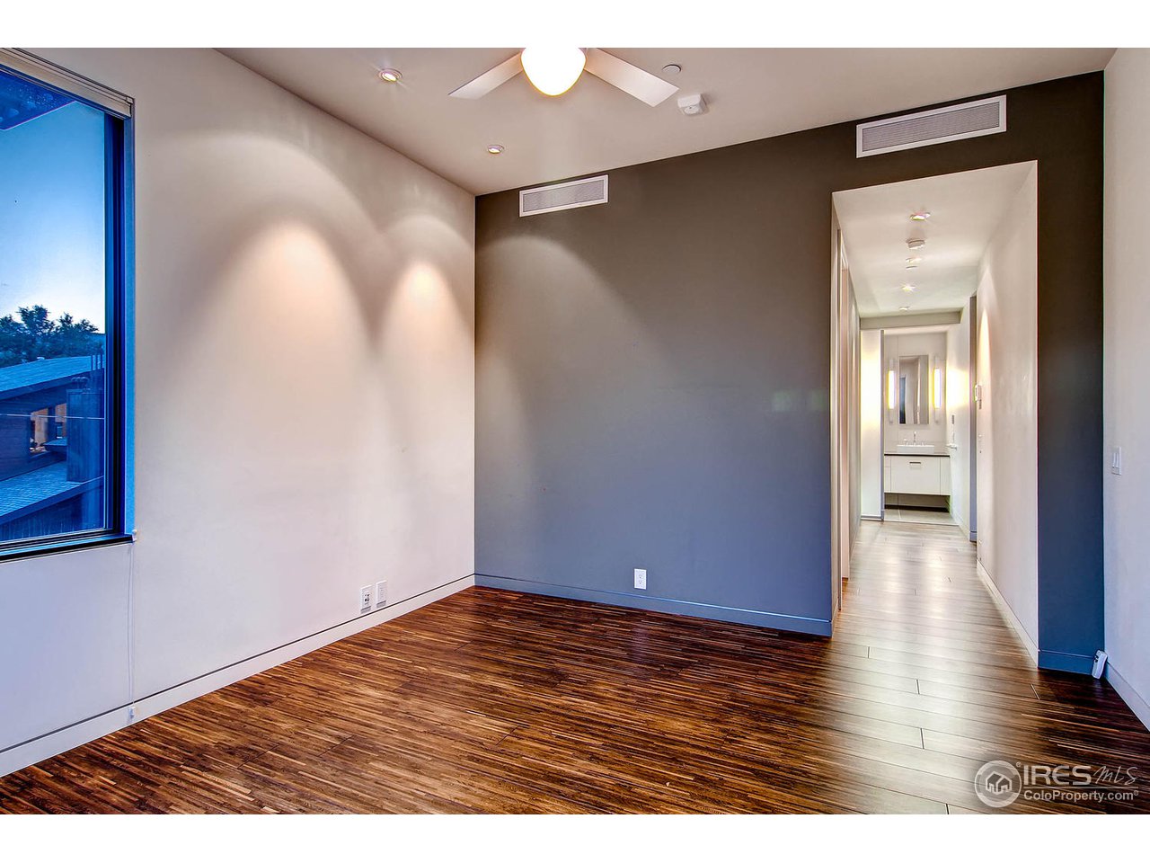 1701 15th Street, Unit 302 Boulder, CO 80302 - Photo 18 of 25 a view of an empty room with wooden floor and a ceiling fan