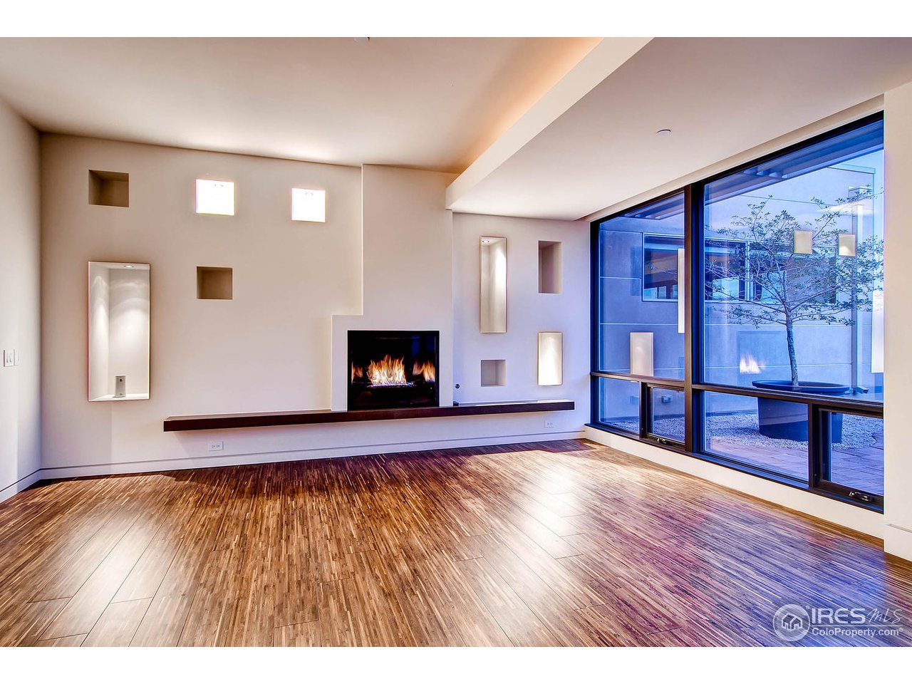 1701 15th Street, Unit 302 Boulder, CO 80302 - Photo 24 of 25 a view of empty room with wooden floor and fireplace
