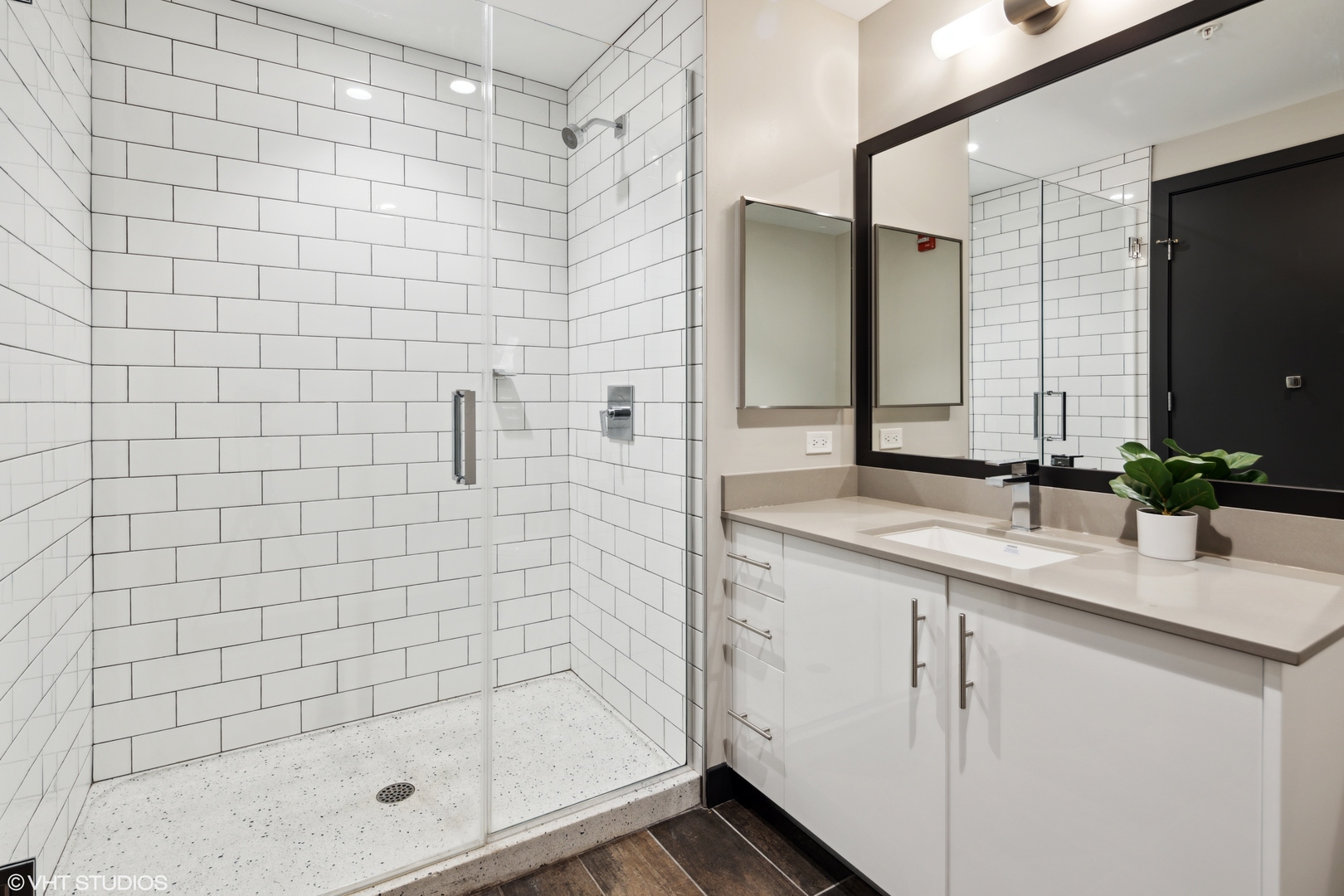 171 North Aberdeen Street, Unit 706 Chicago, IL 60607 - Photo 12 of 20 a bathroom with a shower sink and mirror