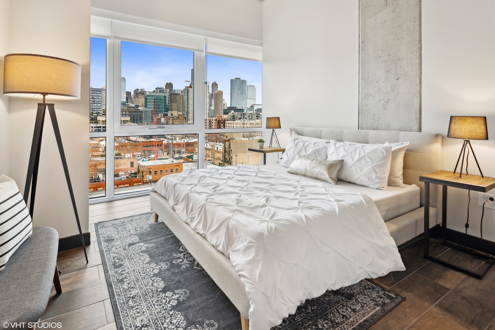 171 North Aberdeen Street, Unit 706 Chicago, IL 60607 - Photo 13 of 20 a large bedroom with a bed and wooden floor