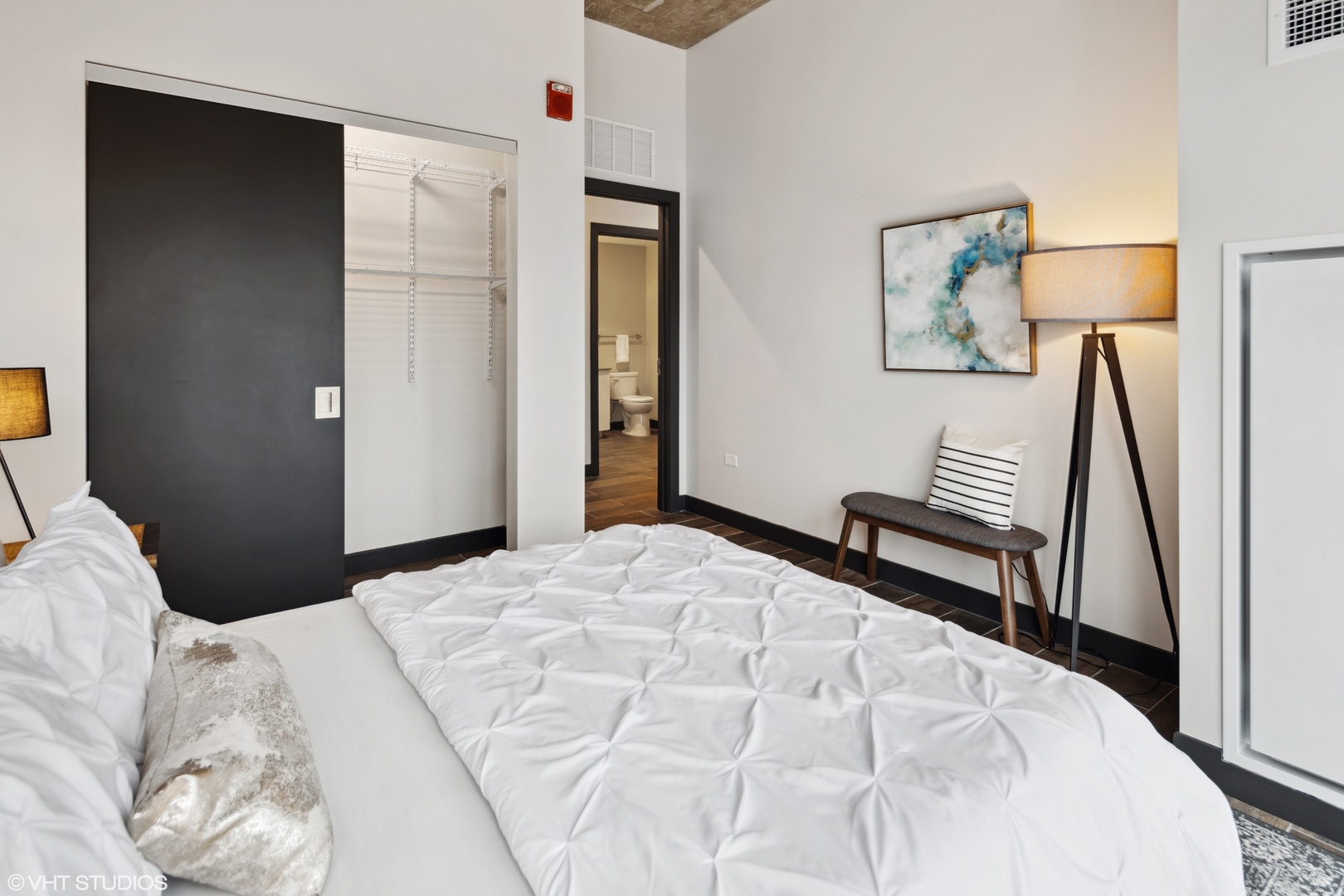 171 North Aberdeen Street, Unit 706 Chicago, IL 60607 - Photo 14 of 20 a bedroom with a bed and a lamp