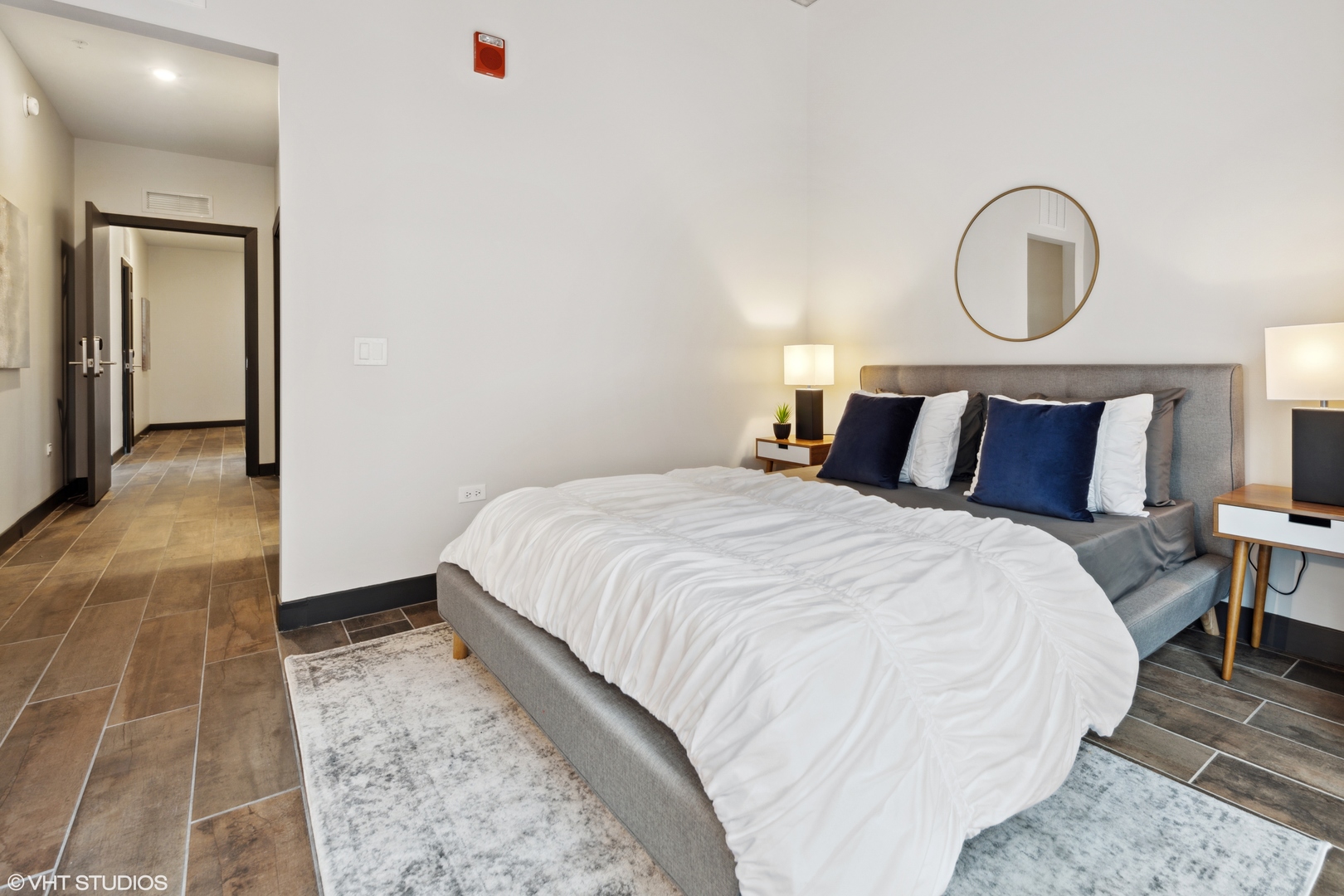 171 North Aberdeen Street, Unit 706 Chicago, IL 60607 - Photo 10 of 20 a bedroom with a bed and a potted plant on dresser