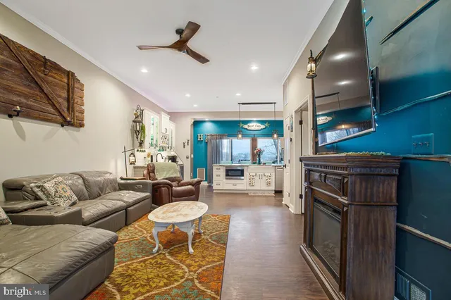 a living room with furniture and a wooden floor