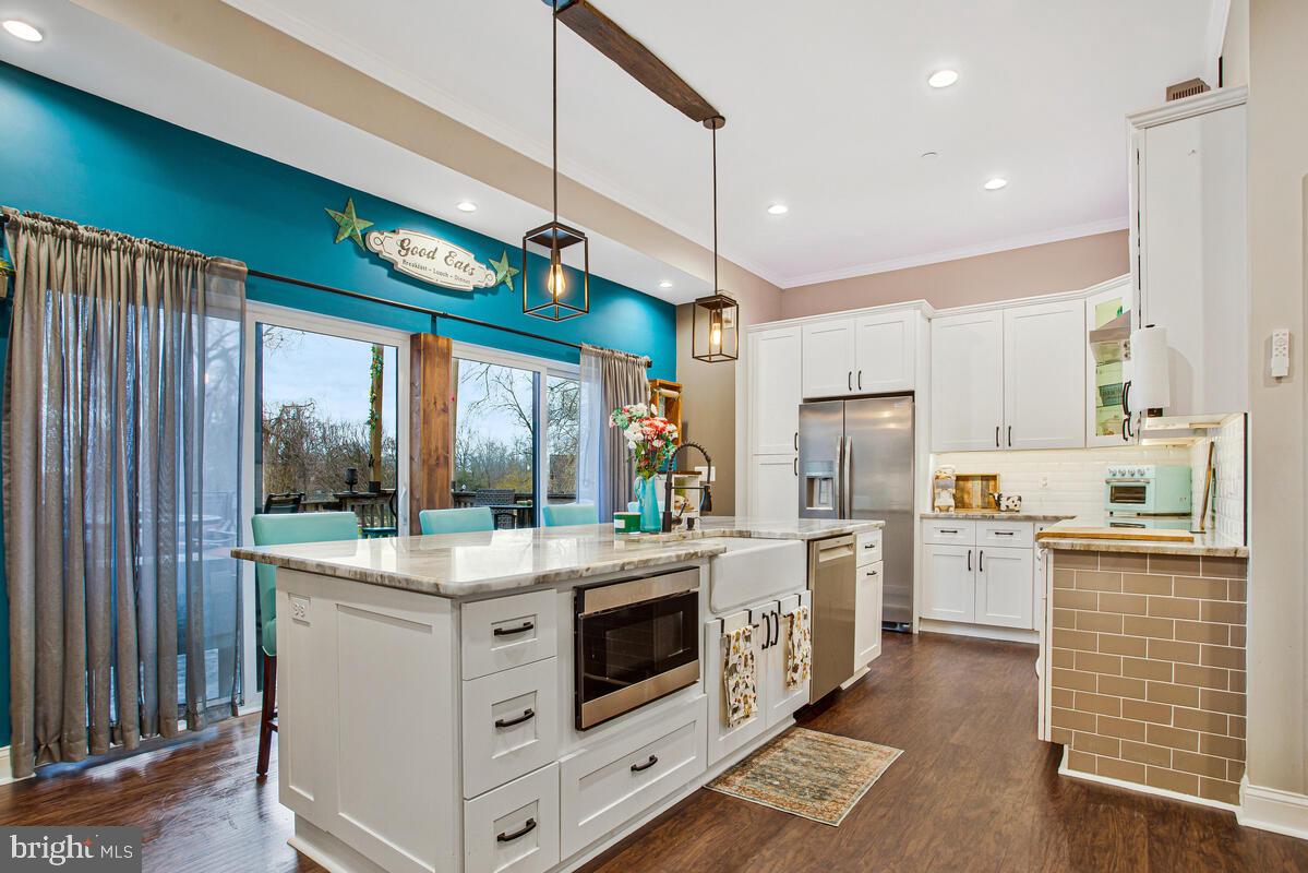 129 Carvel Beach Road Carvel Beach, MD 21226 - Photo 12 of 56 a kitchen with stainless steel appliances granite countertop a stove and refrigerator