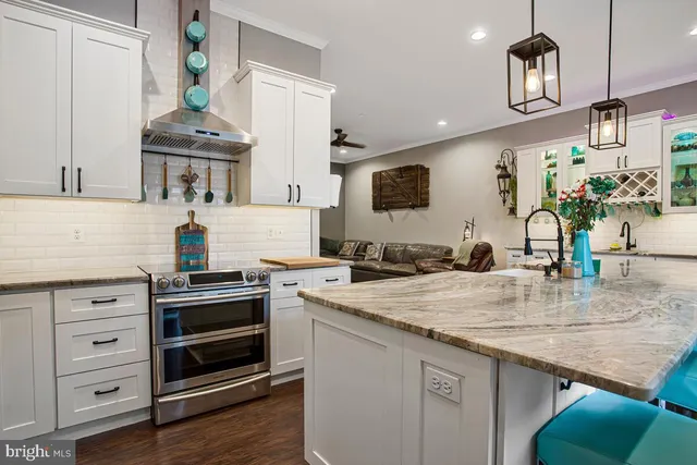 a kitchen with stainless steel appliances granite countertop a stove and refrigerator
