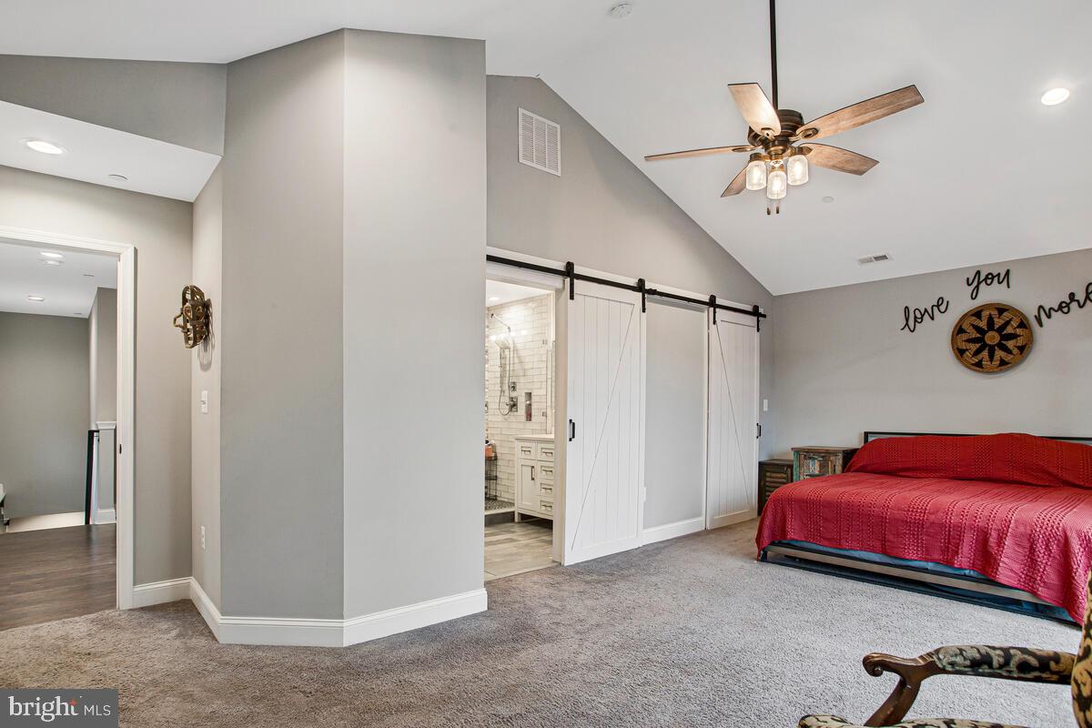 129 Carvel Beach Road Carvel Beach, MD 21226 - Photo 19 of 56 a bedroom with a bed and a chandelier