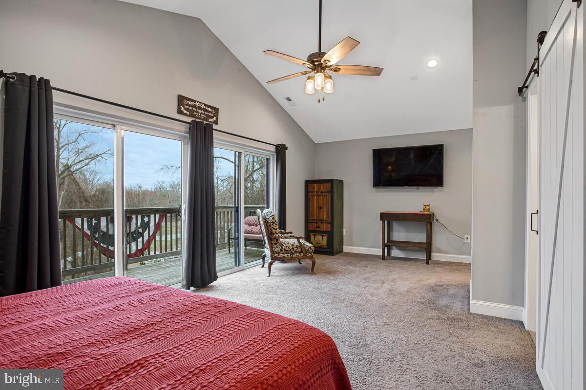 129 Carvel Beach Road Carvel Beach, MD 21226 - Photo 20 of 56 a bedroom with a bed and a flat screen tv