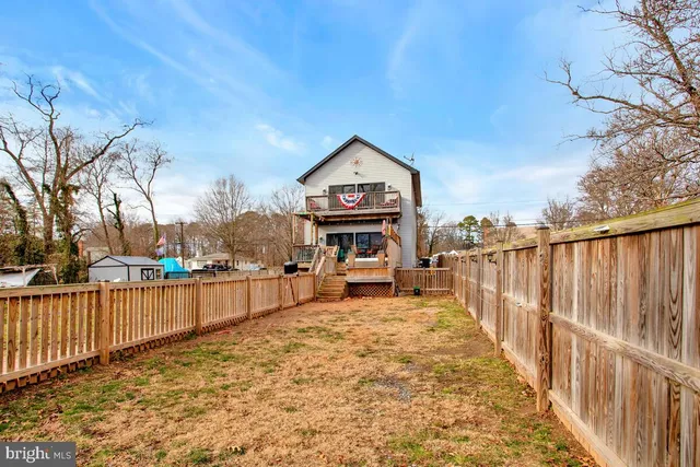 a view of a house with wooden fence