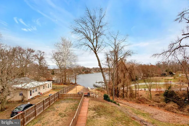 a view of a yard with wooden fence