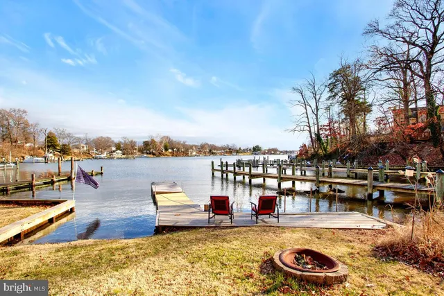 a view of a balcony with chairs and wooden floor