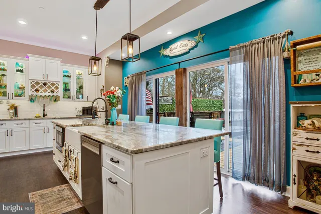 a living room with fireplace furniture wooden floor and a ceiling fan