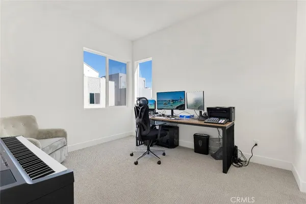 a living room with furniture and a piano