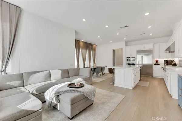 a kitchen with stainless steel appliances a stove a sink dishwasher and a refrigerator