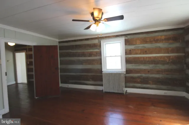 a view of room with wooden floor and a window