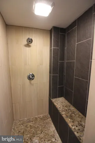 a bathroom with a granite countertop shower and a sink