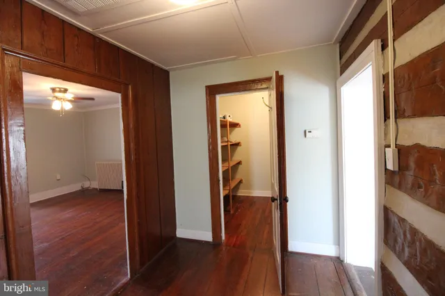 a view of hallway with wooden floor
