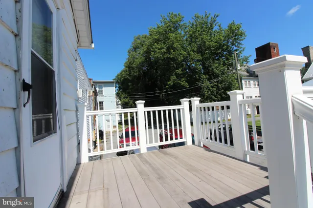 a view of a balcony with furniture and wooden floor