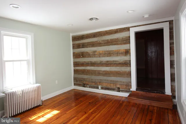 a view of room with wooden floor and window