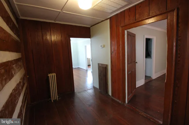 a view of hallway with wooden floor