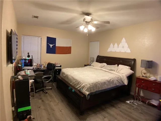 a bedroom with a bed and a chandelier
