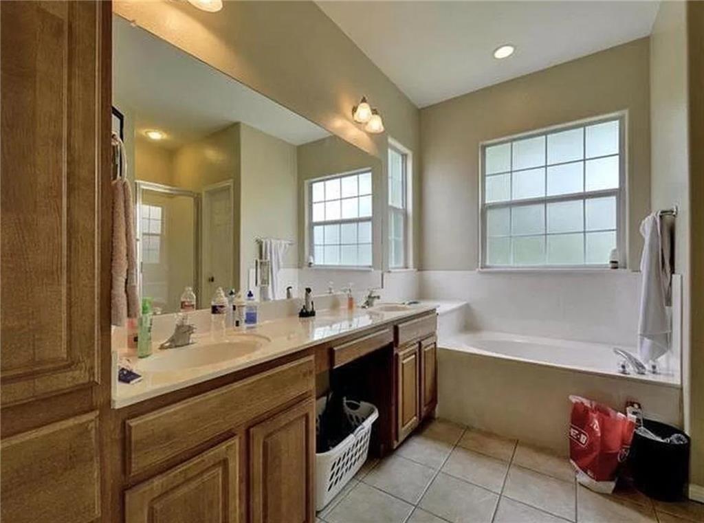 5501 Duval Street, Unit A Austin, TX 78751 - Photo 17 of 23 a bathroom with a tub sink and mirror