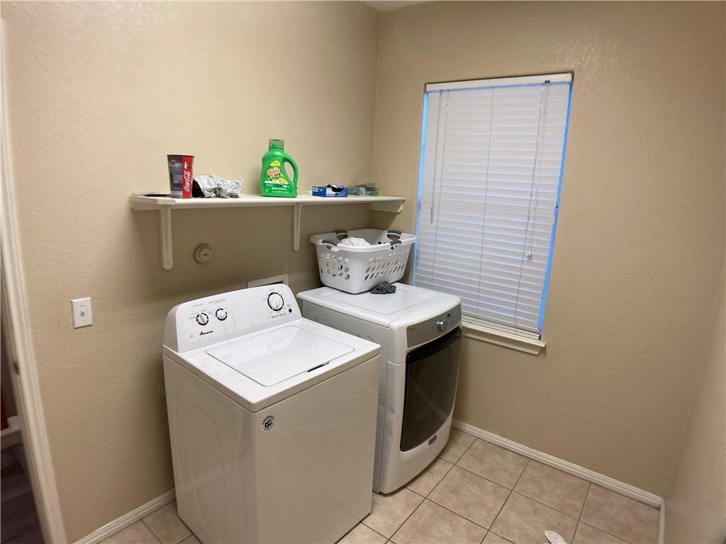5501 Duval Street, Unit A Austin, TX 78751 - Photo 18 of 23 Washroom with a textured wall, independent washer and dryer, and light tile patterned floors
