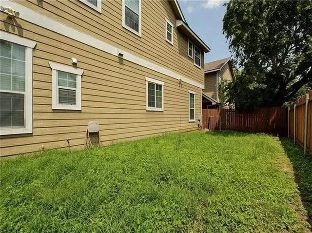 a front view of house with a garden