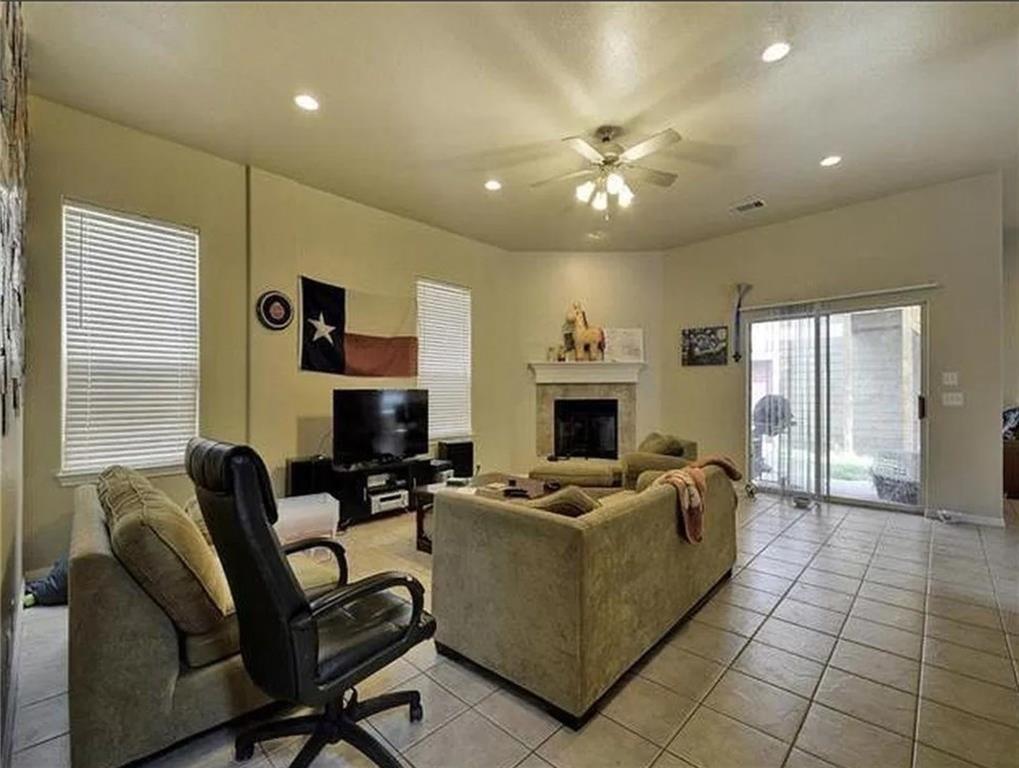 5501 Duval Street, Unit A Austin, TX 78751 - Photo 3 of 23 Living area featuring ceiling fan, light tile patterned floors, a fireplace, and recessed lighting