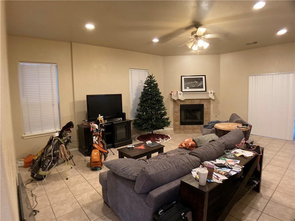 5501 Duval Street, Unit A Austin, TX 78751 - Photo 9 of 23 a living room with furniture a flat screen tv and a fireplace