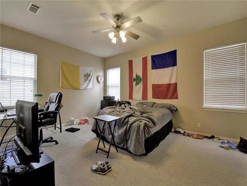 5501 Duval Street, Unit A Austin, TX 78751 - Photo 10 of 23 a spacious bedroom with a bed a desk and chair with window