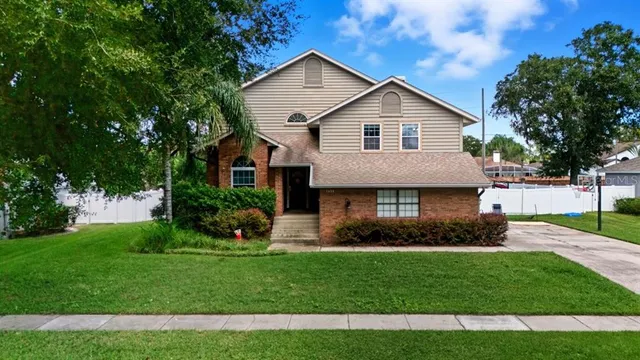 a front view of a house with a garden and plants