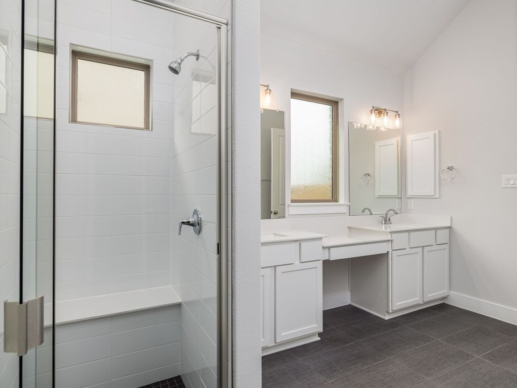 416 Ridgewell Loop Georgetown, TX 78633 - Photo 11 of 19 a bathroom with a double vanity sink mirror and bathtub