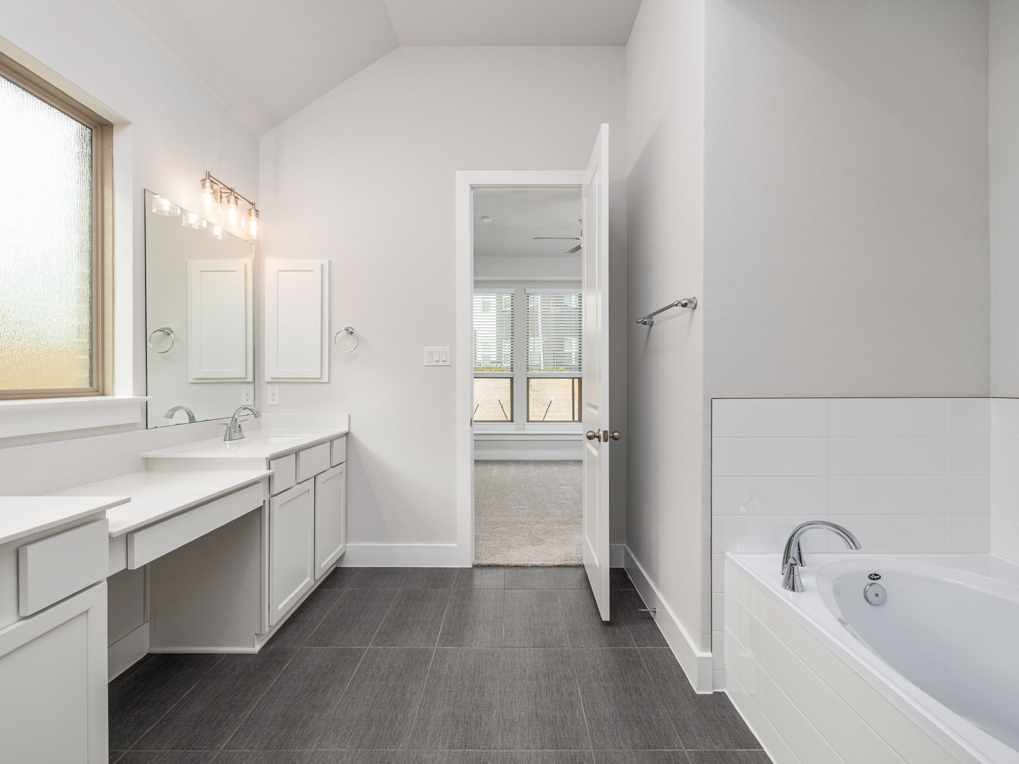 416 Ridgewell Loop Georgetown, TX 78633 - Photo 12 of 19 a bathroom with a tub sink and mirror