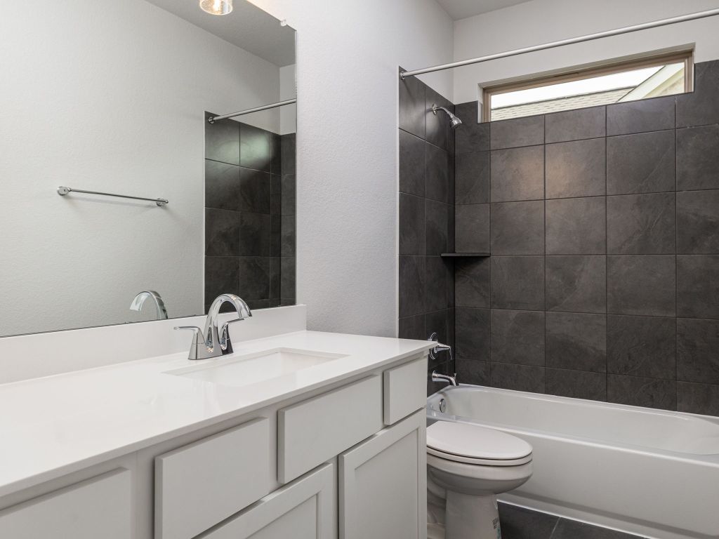 416 Ridgewell Loop Georgetown, TX 78633 - Photo 14 of 19 a bathroom with a sink a toilet and shower