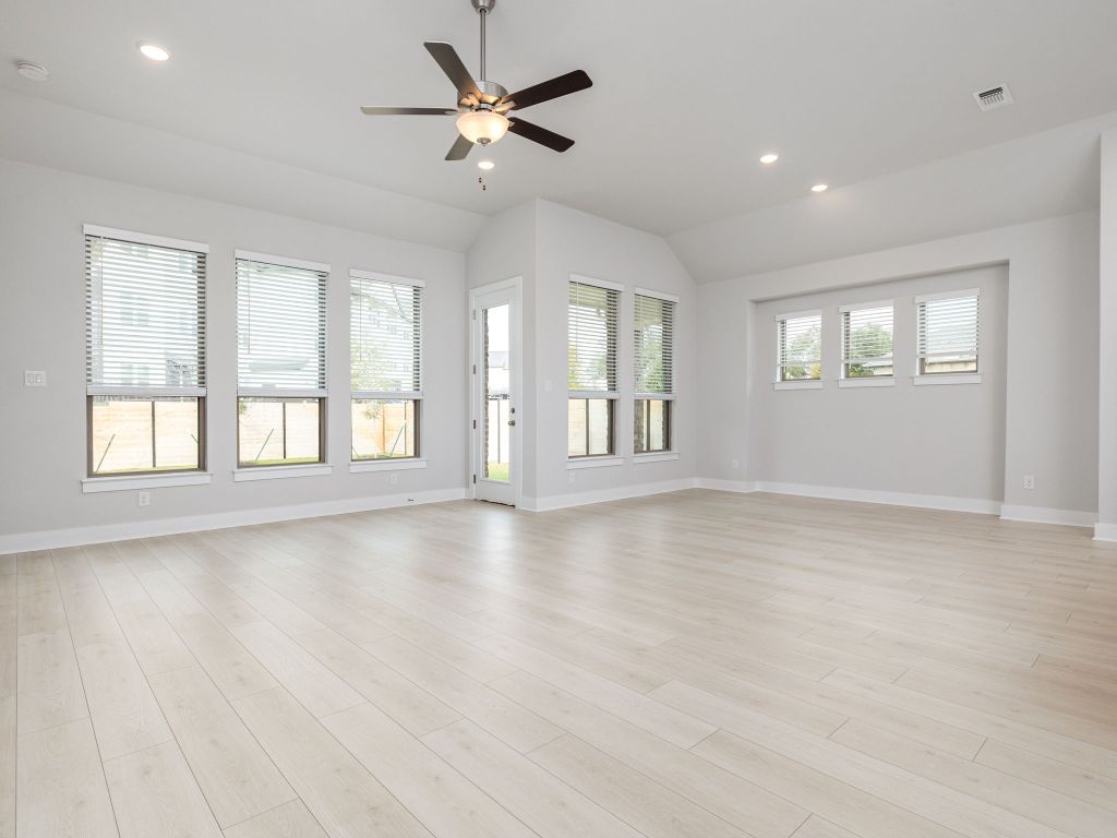 416 Ridgewell Loop Georgetown, TX 78633 - Photo 3 of 19 a view of an empty room with wooden floor and a window