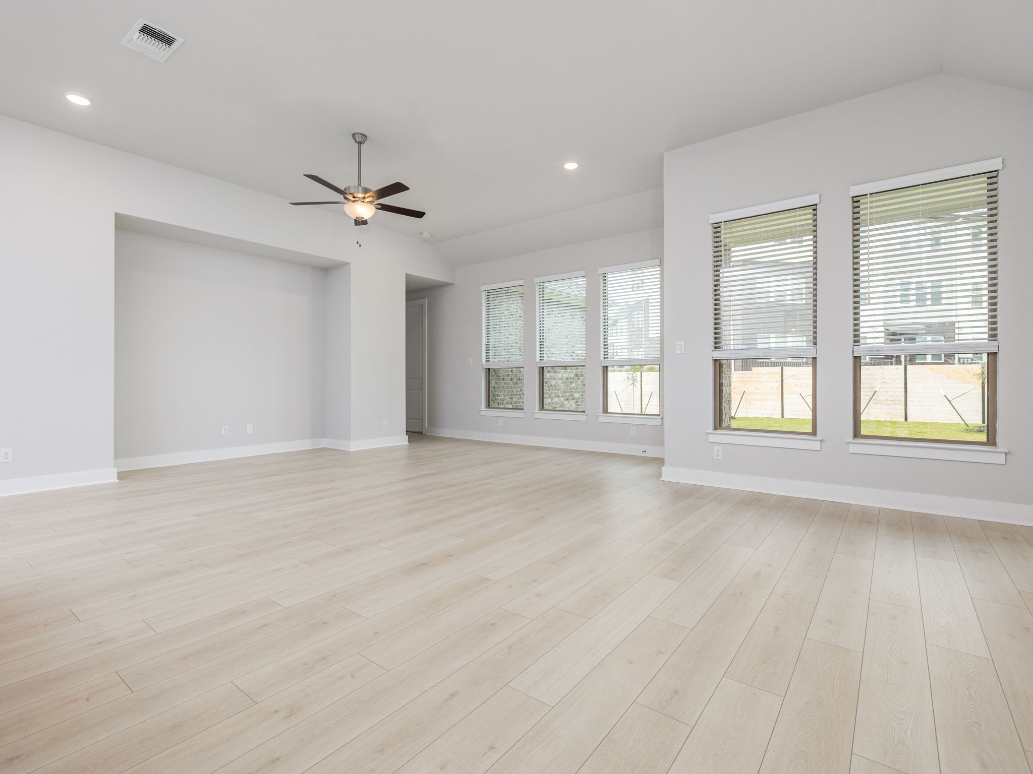 416 Ridgewell Loop Georgetown, TX 78633 - Photo 4 of 19 a view of an empty room with a window and wooden floor