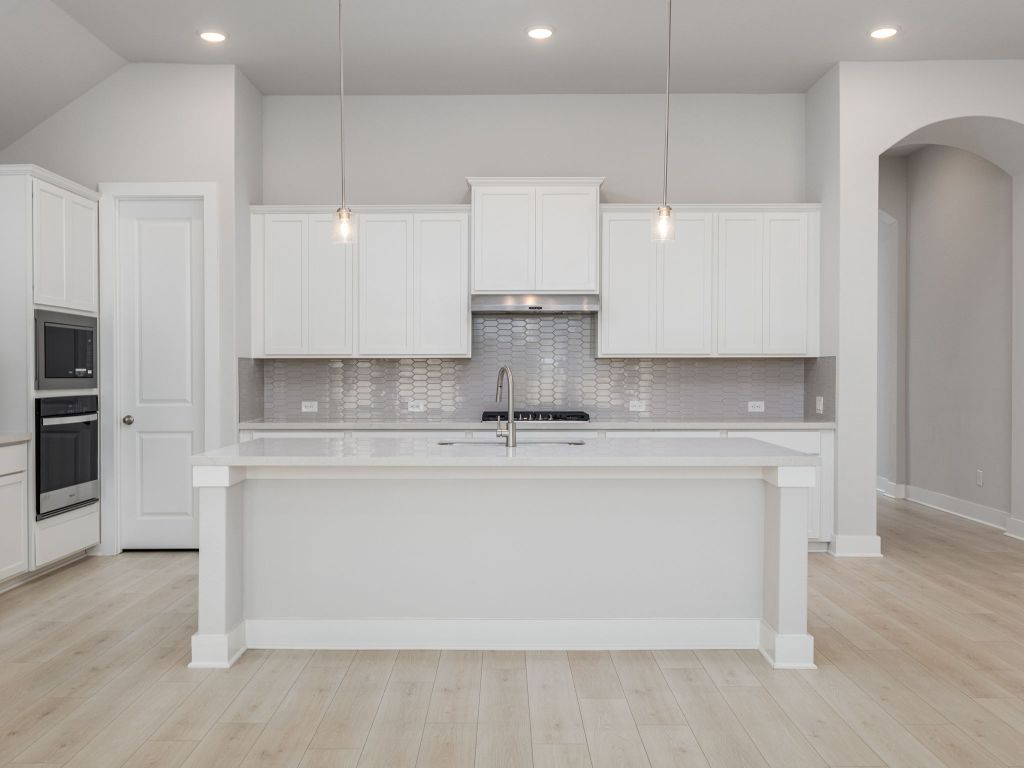 416 Ridgewell Loop Georgetown, TX 78633 - Photo 5 of 19 a view of kitchen with stainless steel appliances granite countertop cabinets and wooden floor